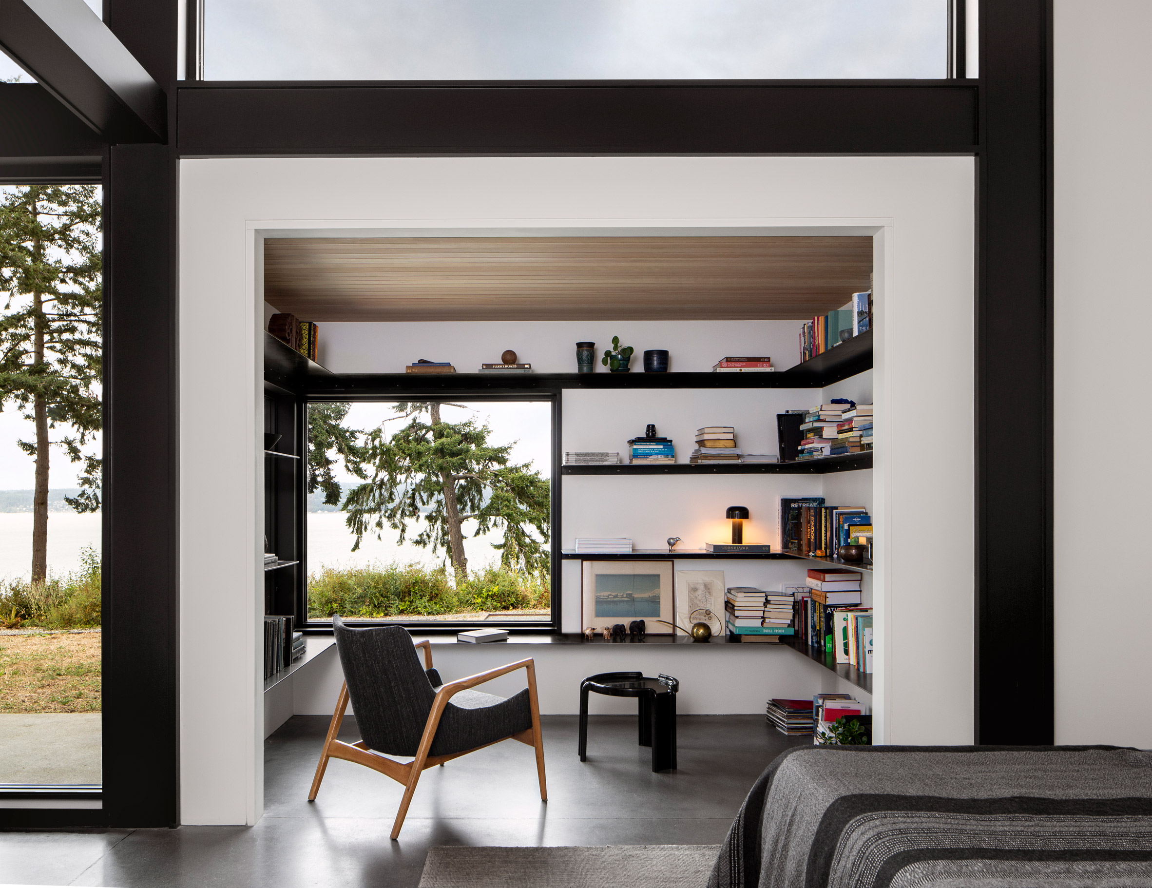 Reading nook with white walls and black shelving